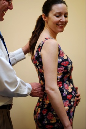 Chiropractor examining a patient’s back and posture